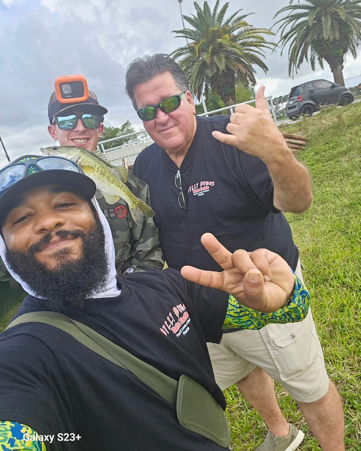 Three regulars in Billy Bones shirts with a largemouth bass